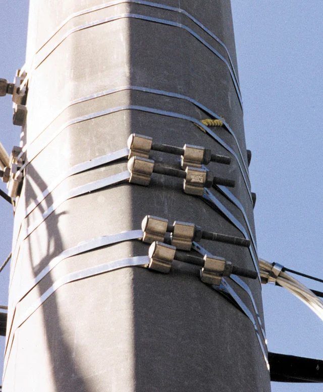 Band-It stainless steel bolt clamps securing bands around a pole